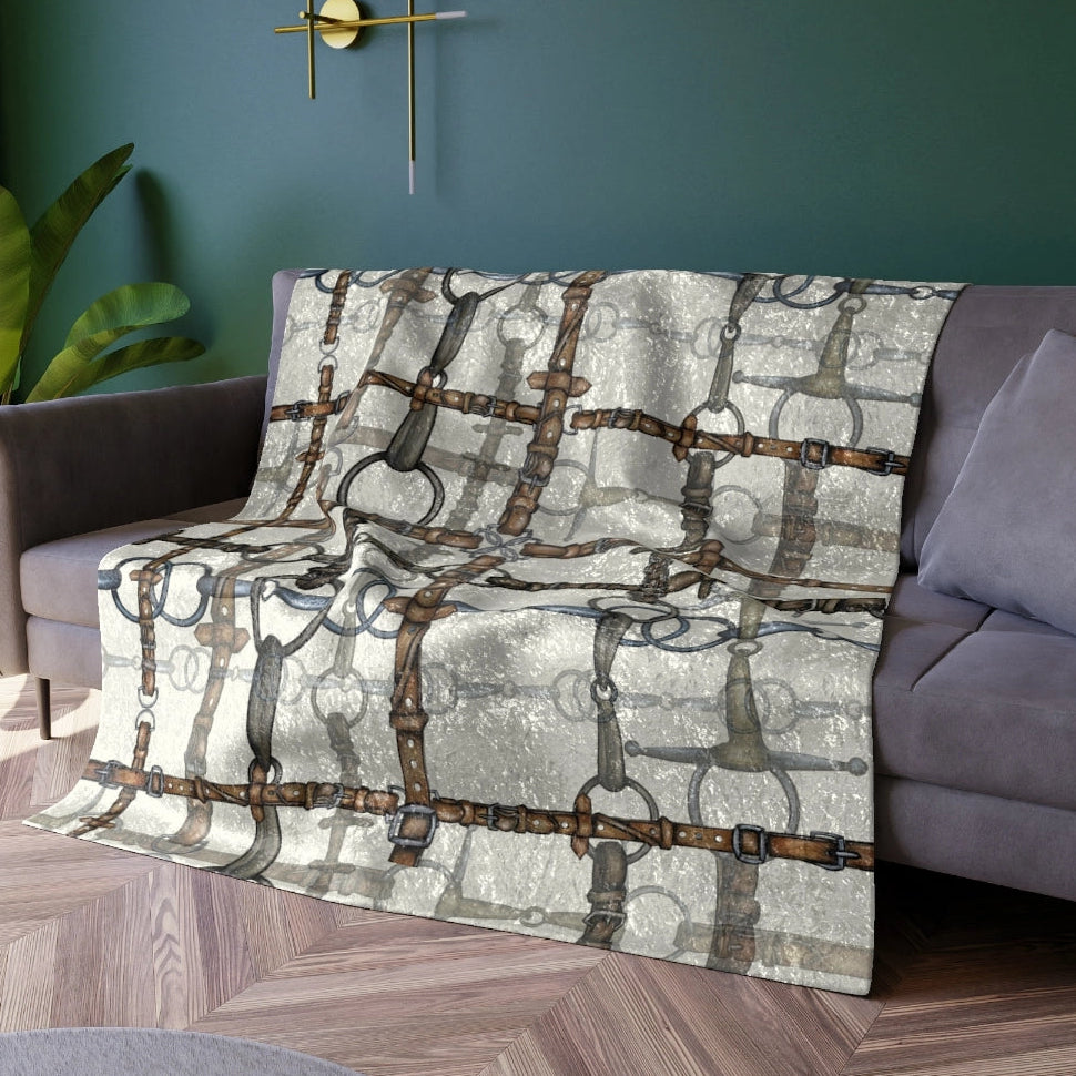 Decorative throw blanket with geometric pattern on a sofa in a living room.