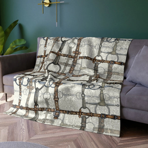Decorative throw blanket with geometric pattern on a sofa in a living room.