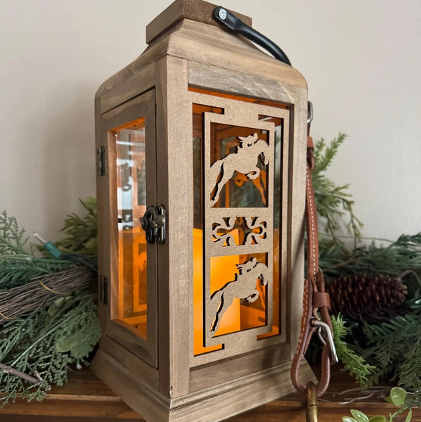 Wooden lantern with horse designs on a decorative shelf