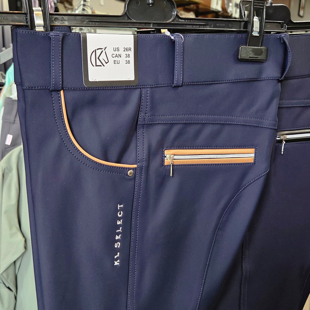 Navy blue pants with a brand label on a hanger in a store setting.