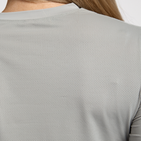 Gray long-sleeve athletic shirt worn by a person on a light gray background