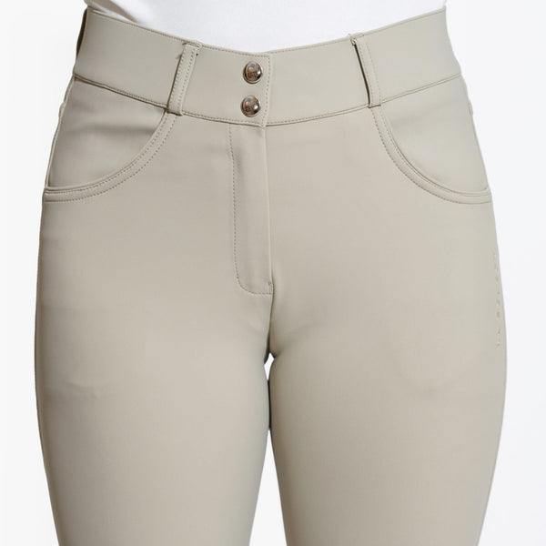 Close-up of beige equestrian riding pants featuring a knee patch and pockets.