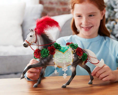 Decorative horse figure with red and green ornaments on a white background