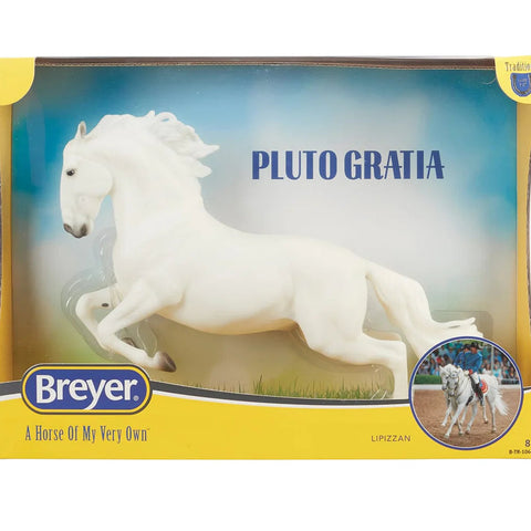White horse figurine on grass with a blue sky background