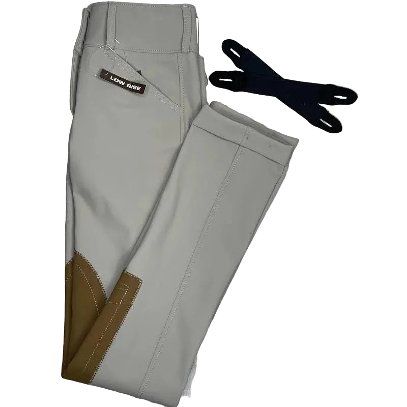 Gray riding pants with brown accents and a black glove on a textured surface